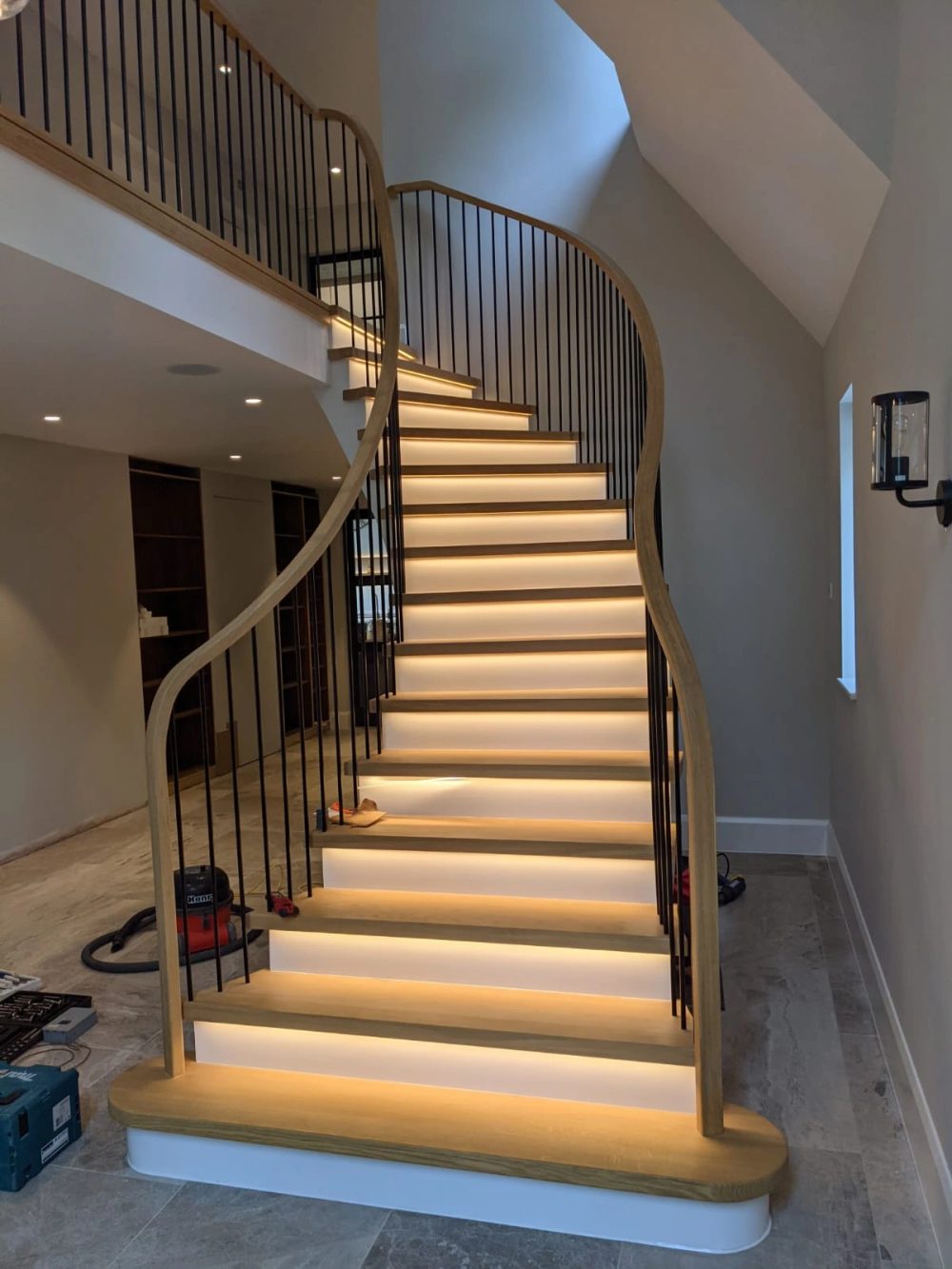 Painted helical staircase with continuous hardwood handrail