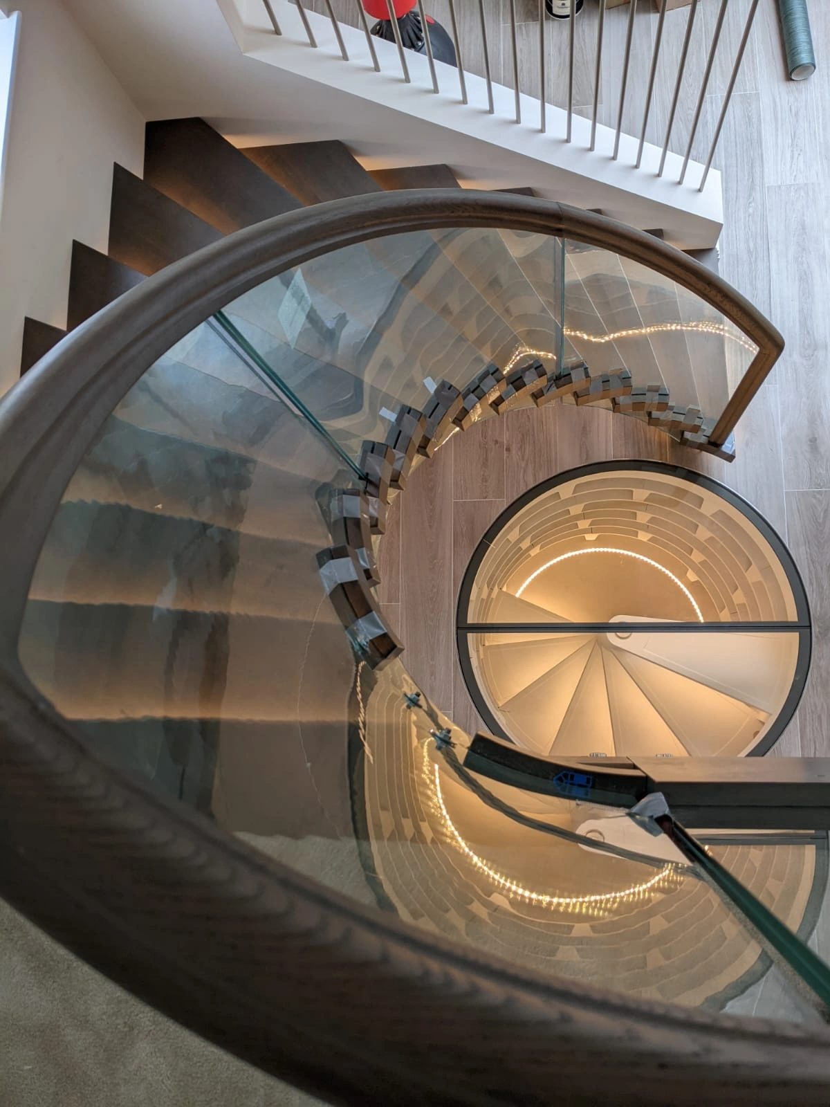 Spiral timber staircase viewed from the landing above