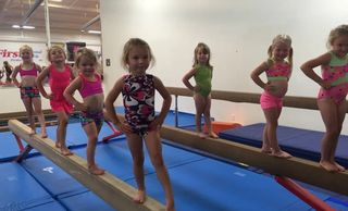 girls gymnastics balance beam vault uneven bars competitive competition team recreational fun kids