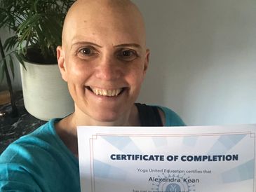 Alex holding yoga therapy diploma certificate