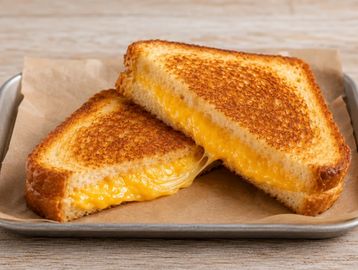 A grilled cheese sandwich cut in half.