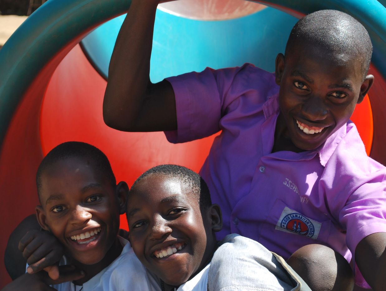 Dennis, David and John slid down the slide at Entebbe zoo during the 2022 school study tour.