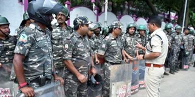 Police officers in uniform standing in a line outdoors.