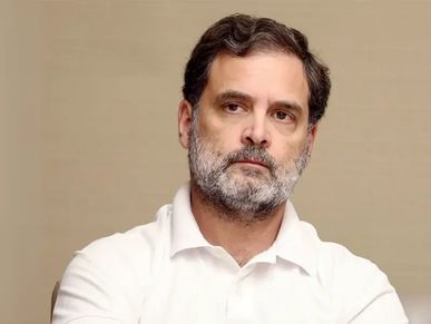 Man with a serious expression in a white shirt.