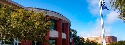 Charleston Area Convention Center.  A rounded brick building with a flagpole.