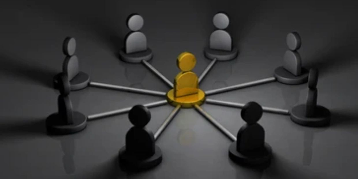 Golden figure in the center connected to black figures around it.