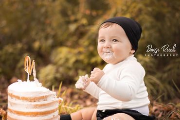 baby with cake on grass