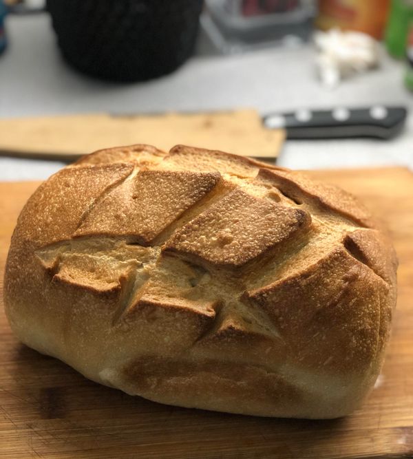 Freshly baked artisanal bread on a wooden cutting board.