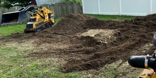 Small excavator working on a backyard digging project.
