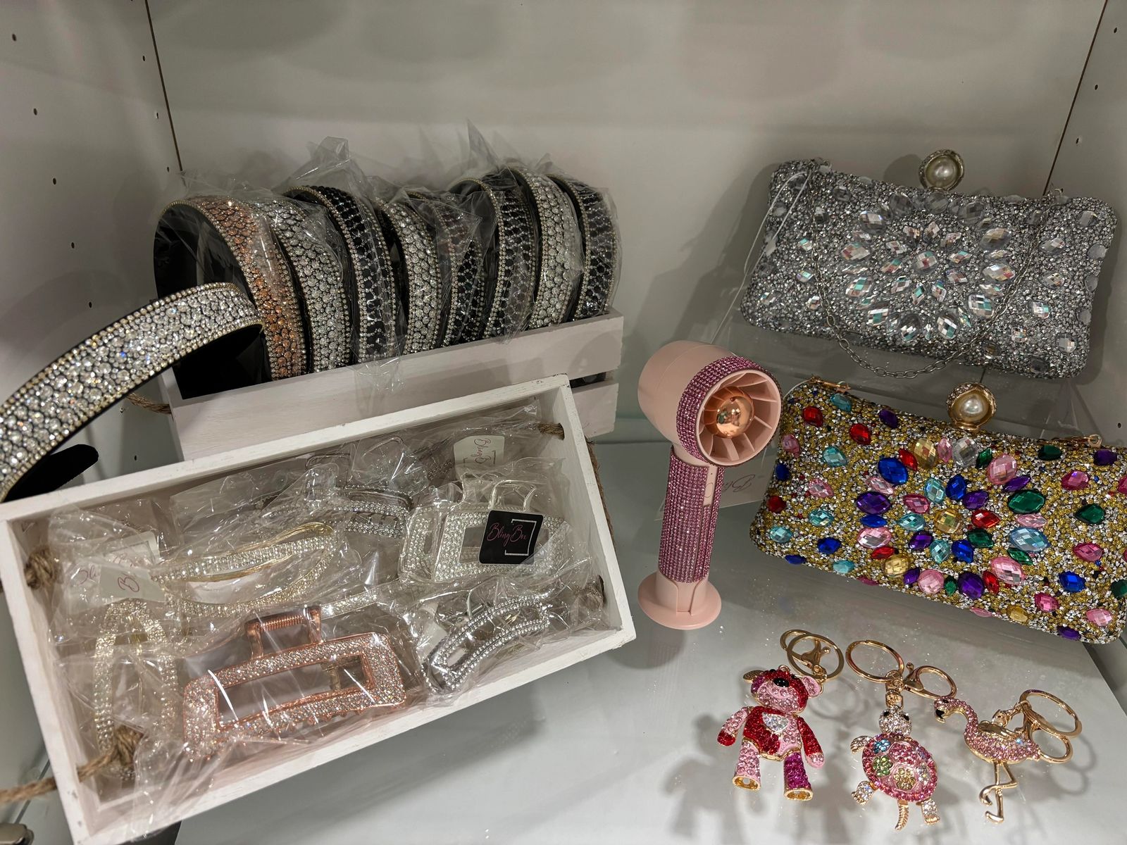 Rhinestone headbands, bejeweled clutches, hair clips, and keychains on display at BlingBox