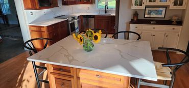 Modern kitchen island with sunflowers in a glass vase.