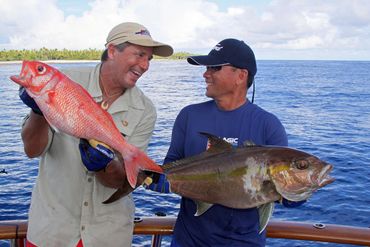 Deep drop fishing for delicious table fish. two Moorea Sport fishing guests are happy with their cat