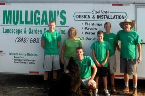 Picture of the Mulligan family and their pet newfoundland dog