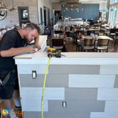 A man working on a construction project inside a restaurant.