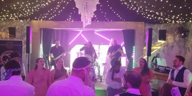 Band performing at wedding with people