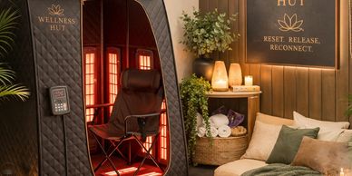A cozy wellness space with an infrared sauna and relaxing seating area.