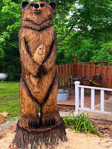 This bear is 7’7” tall carved from a massive  loblolly pine  with a nature finish. 
