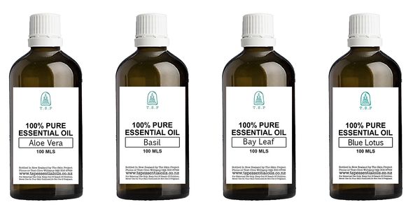 Four bottles of 100% pure essential oils with different labels.