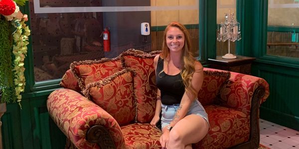 Megan Martin sitting on a couch in a cafe