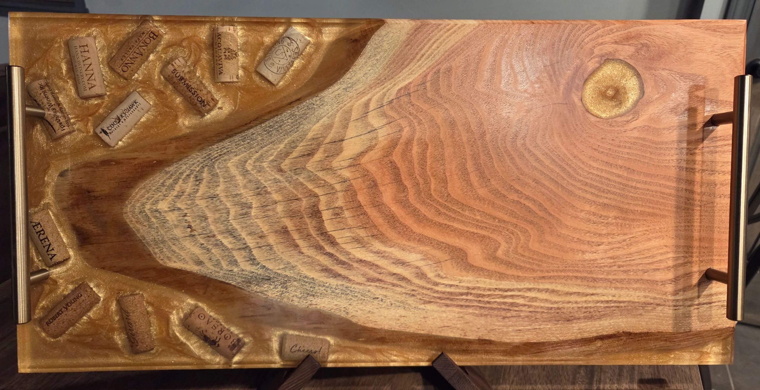 Wooden serving tray with embedded wine corks and resin accents.