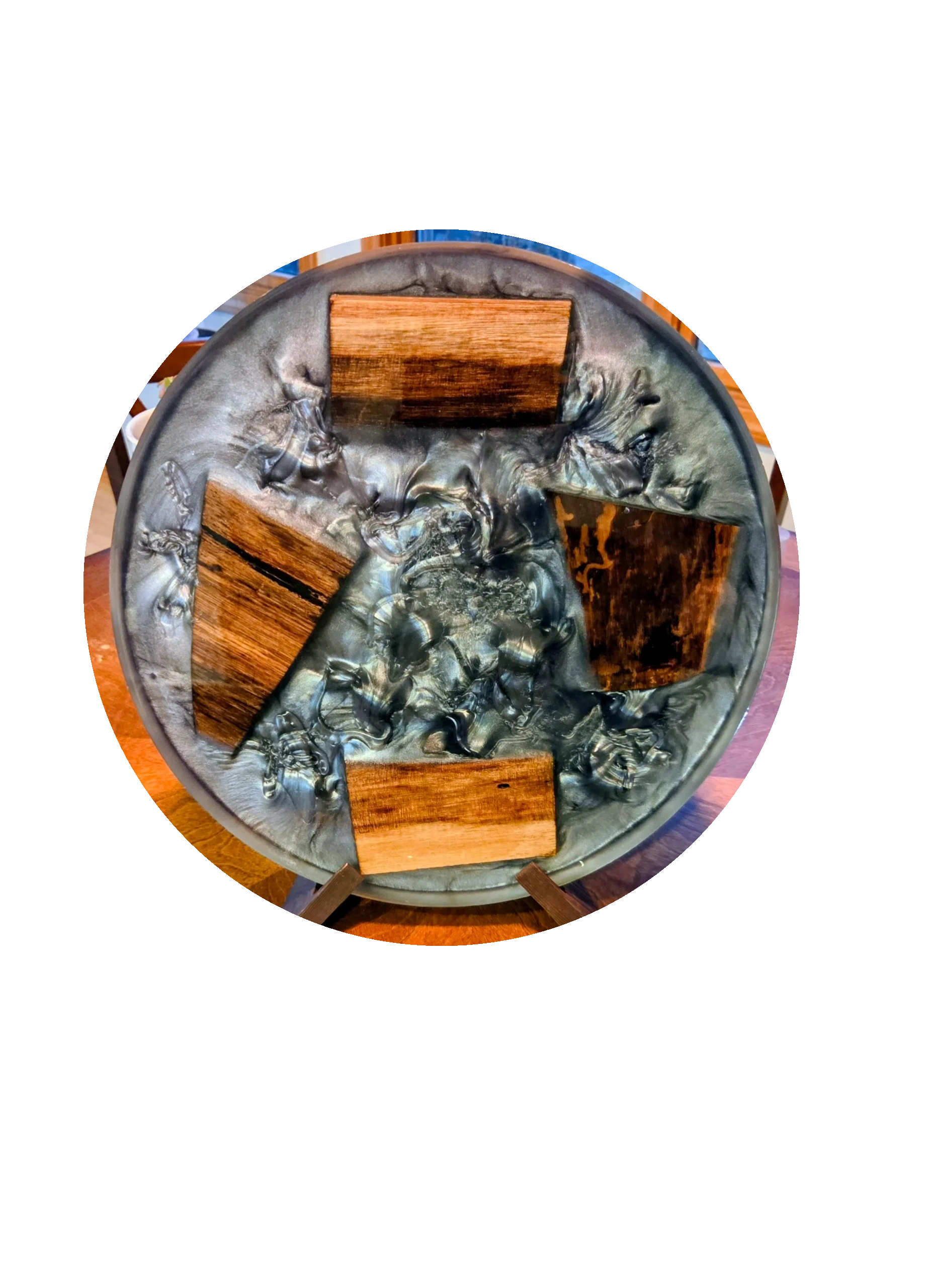 Round art piece with wood and metallic textures.