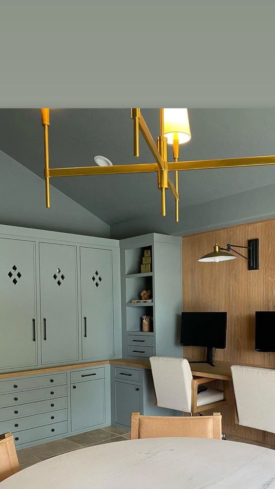 Modern home office with built-in green finished cabinets and stained wood accents