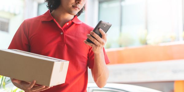 Delivery Personnel using a phone for coordination