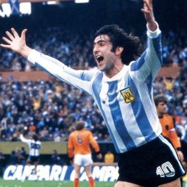 Argentinian soccer player celebrating a goal during a match.
