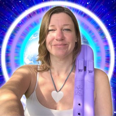 A woman with a heart necklace smiles, holding a purple object with Earth and cosmic rings in the background.
