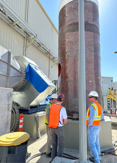 American Fiberglass Services technicians inspecting scrubber inlet nozzle and tower shell at an industrial facility.