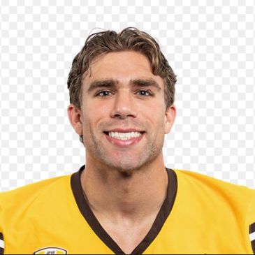 Smiling young male athlete in yellow sports jersey.