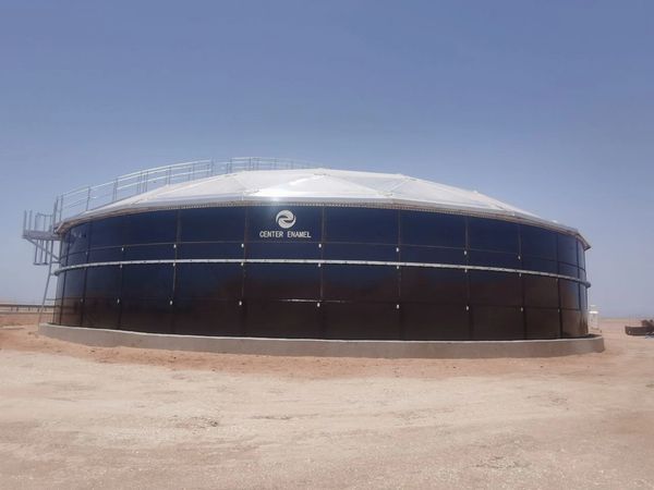 Large industrial storage tank labeled Center Enamel in a desert area.