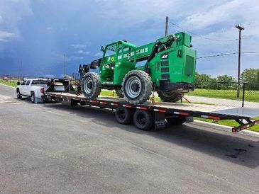 a truck towing a farm equipment