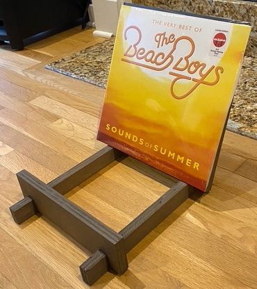 A wooden vinyl record organizer by Gator Bill Furnishings.