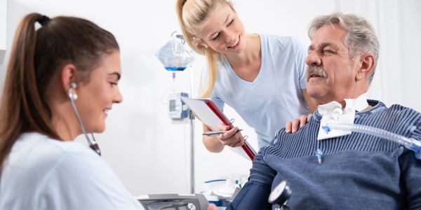 Nurses taking care of a patient on a home ventilator