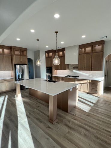 Modern kitchen with large island and wooden cabinetry.