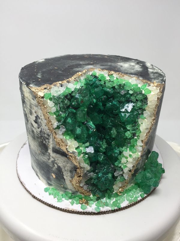 gray cake with green geodes on the side