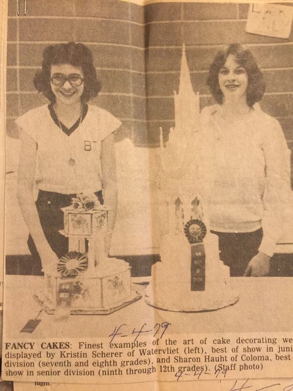 newspaper clipping of 2 people and their prize winning cakes