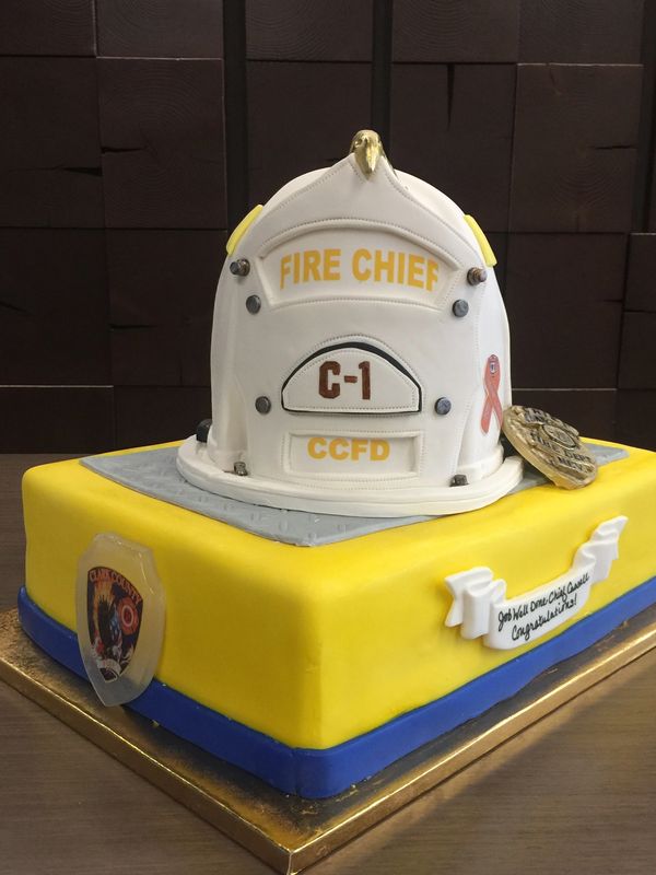 yellow Cake with fire chief helmet and badge o