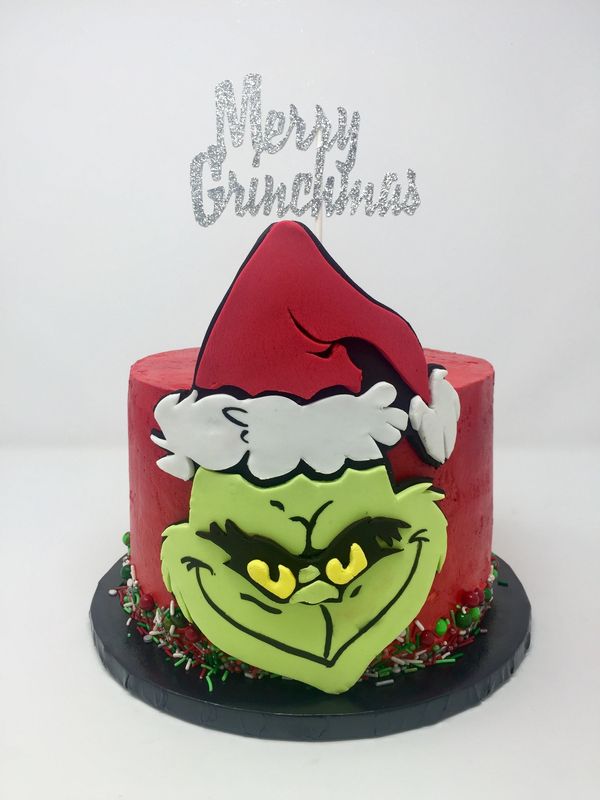Red cake with fondant grinch on side.