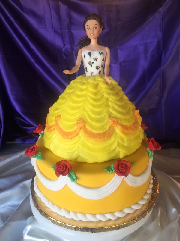 2 tiered yellow cake with yellow princess on top