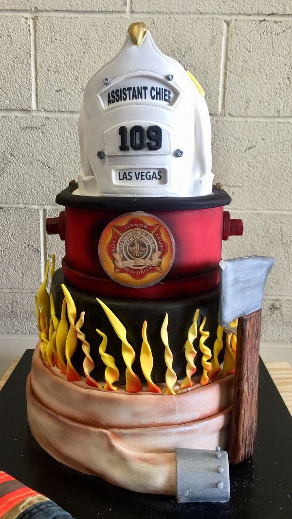 4 tier cake with fire hose, flames, fire hydrant, and fireman's helmet.