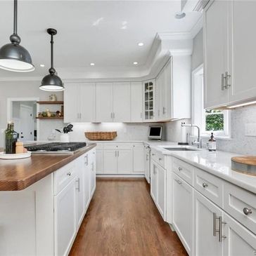 High end kitchen remodel with tile backsplash installation, marble countertops and kitchen island 