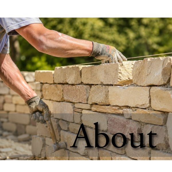 Builder constructing a stone wall with a hammer and gloves.