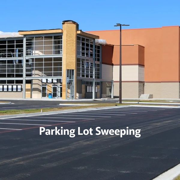 Empty parking lot in front of a modern building under construction.