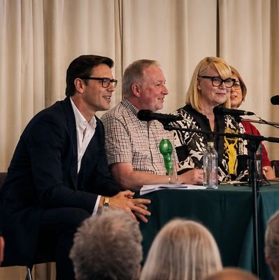 Group of people speaking at a panel discussion.