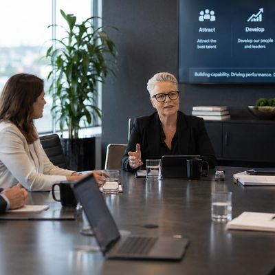 Business meeting with diverse professionals discussing strategy in a conference room.