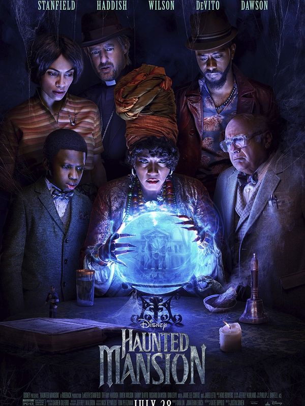 Group gazing into a glowing crystal ball in Disney's Haunted Mansion poster.