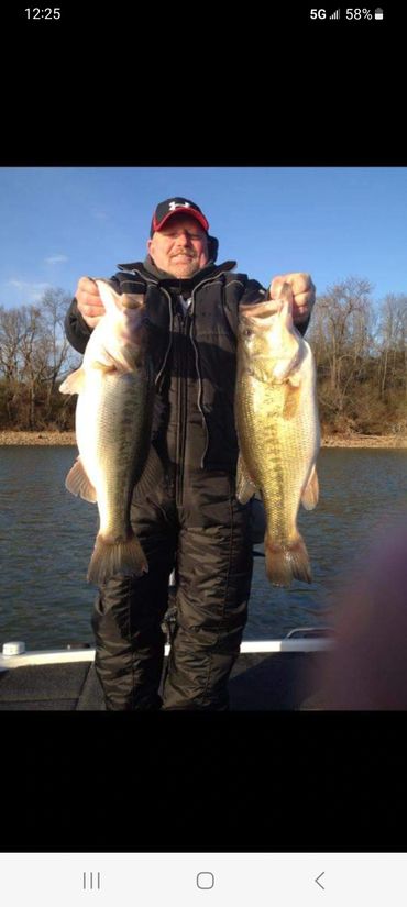 A fisherman holding a bass