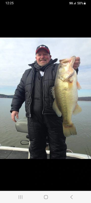 A fisherman holding a bass